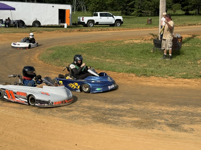 Ronnie's blue 3 kart lined up alongside other karts on the dirt