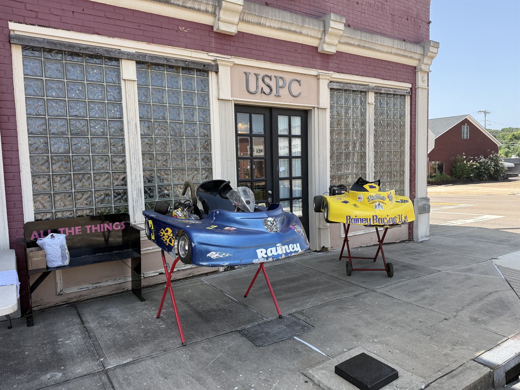 Both Rainey Racing karts on display outside the shop doors on the Court Square