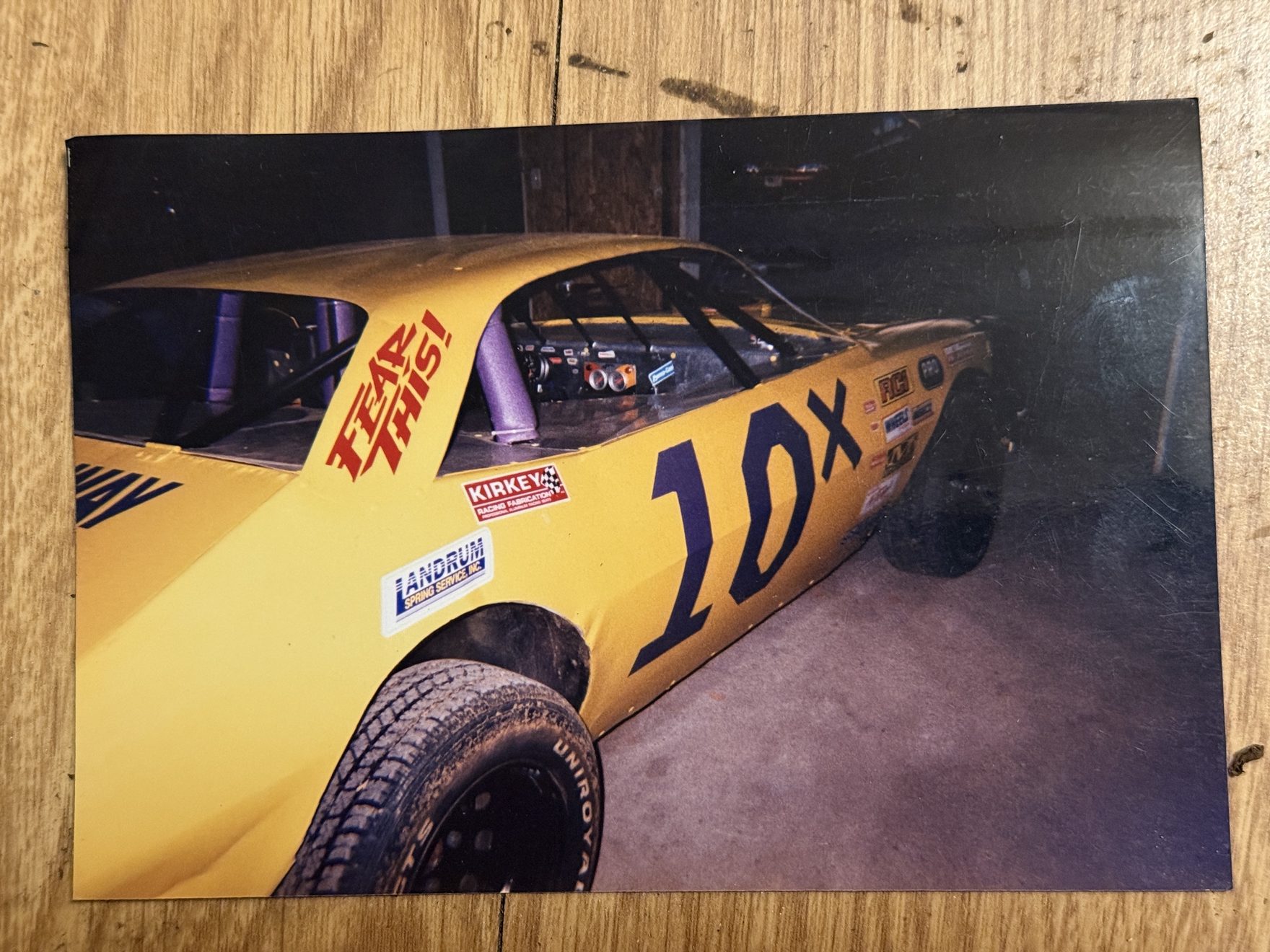 The yellow 10X Mini Stock in the shop, showing the purple 10X, the FEAR THIS! lettering and the purple-padded roll cage