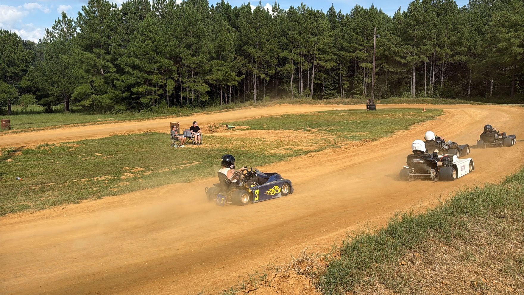 Ronnie's blue 3 kart running down the dirt at Camden Speedway with the pack ahead