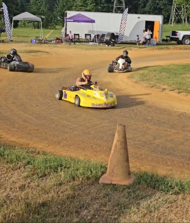 Travis in the yellow 10X running down two karts through the corner in the Box Stock feature