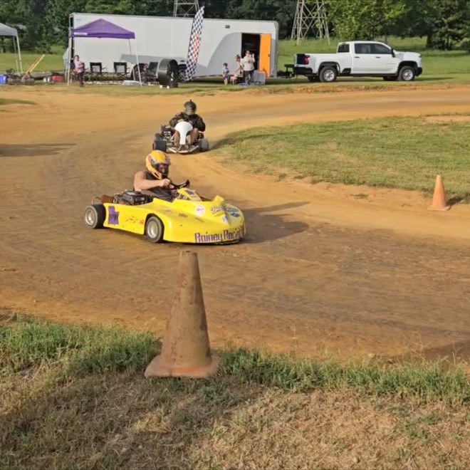 Travis's yellow 10X kart rolling out of the corner at Camden Speedway
