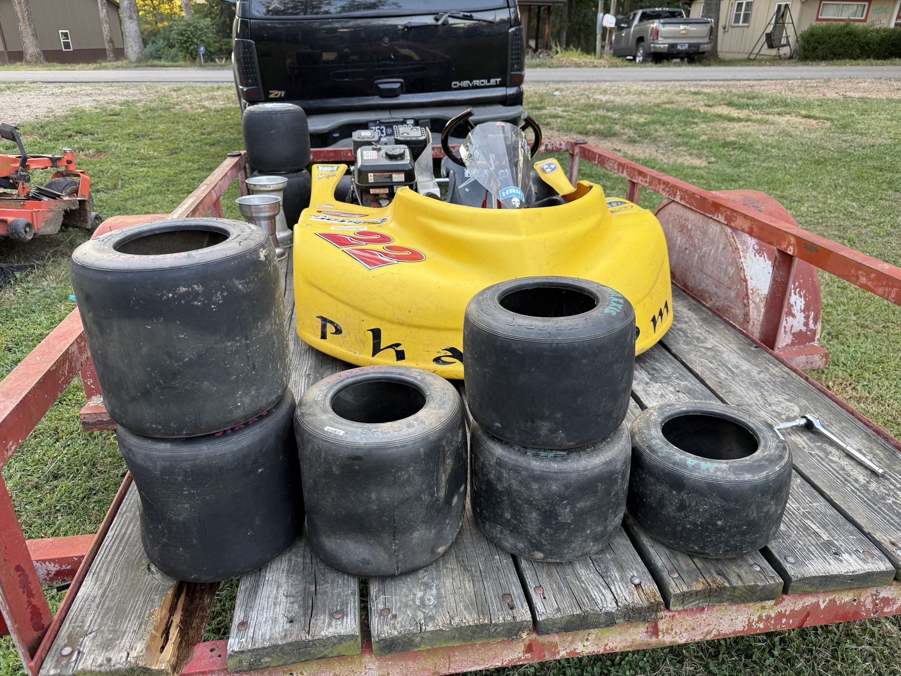The new kart on the trailer with a stack of spare tires the night it came home