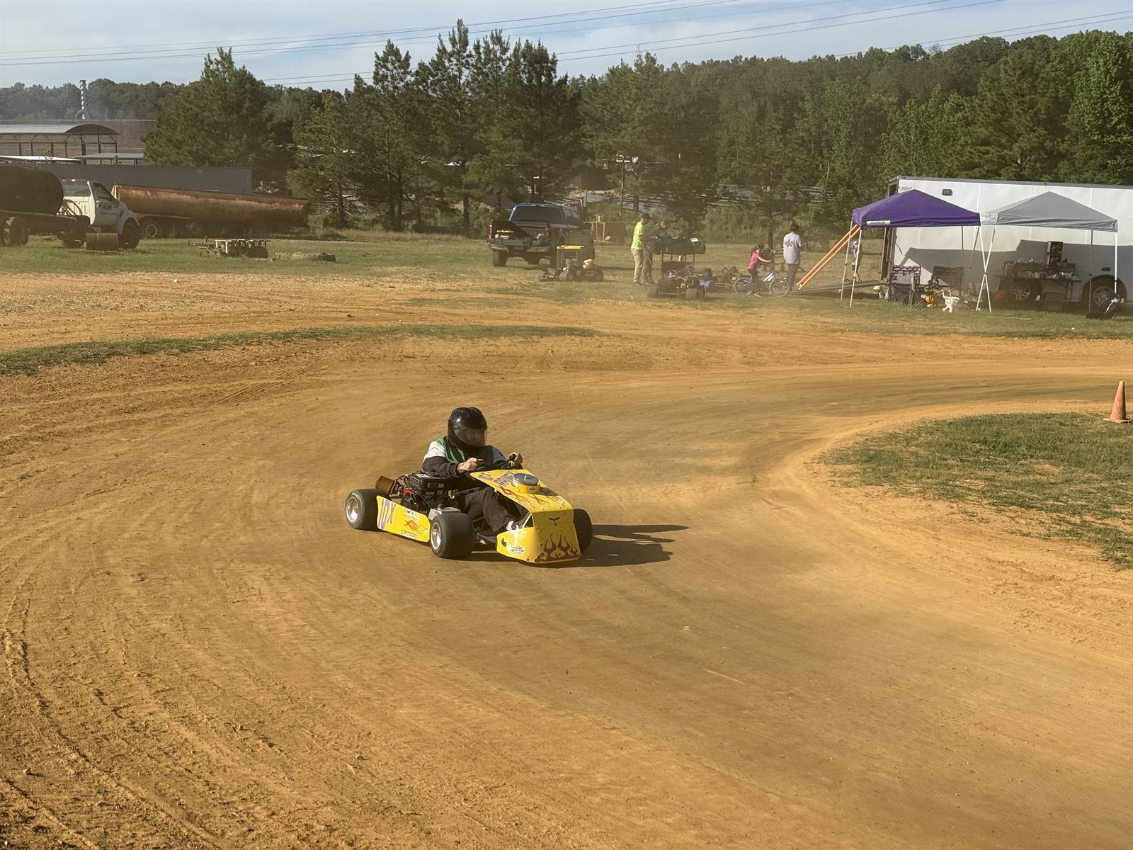 Ronnie Rainey driving Travis's borrowed yellow 10X kart through the corner during the Clone Class feature — his 2nd-place run