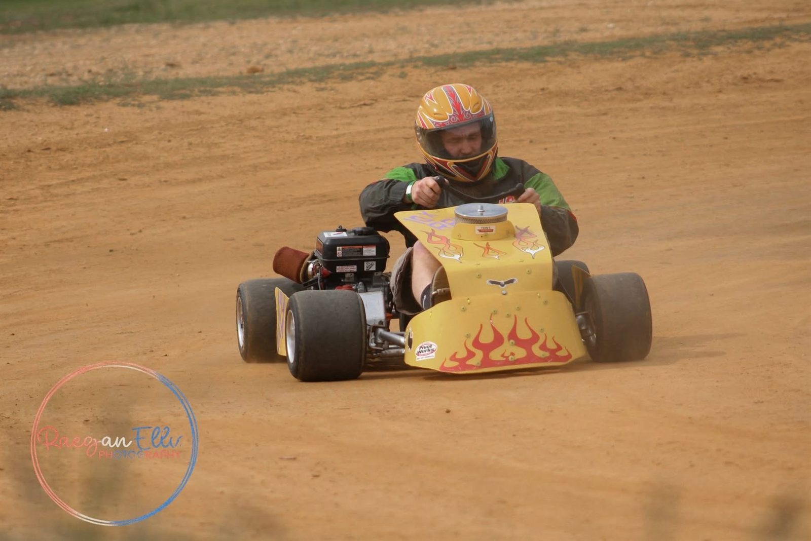 Travis Rainey sliding the yellow and purple 10X through the dirt at Camden Speedway