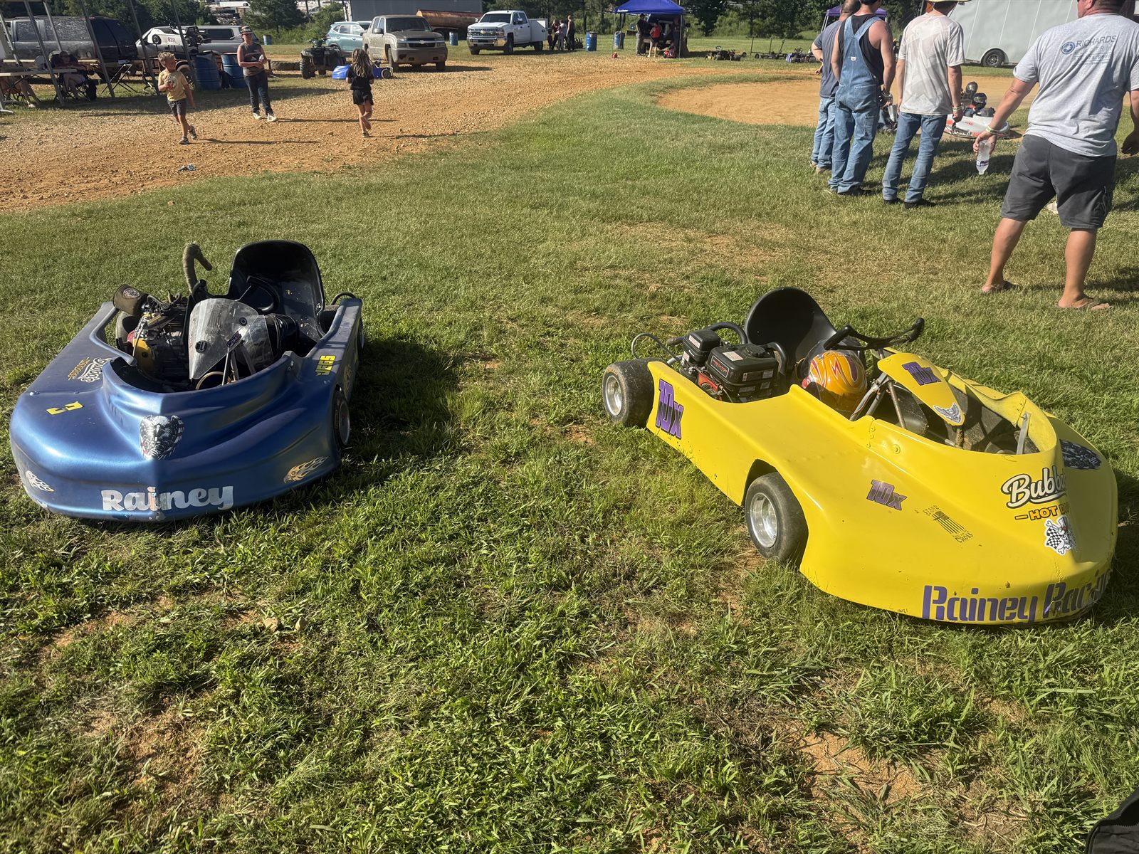 The Rainey Racing karts — Ronnie's blue 3 and Travis's yellow 10X — side by side at Camden Speedway