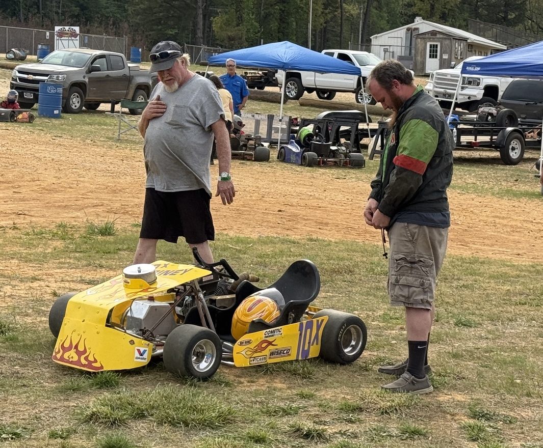 Ronnie Rainey Sr. looking over the 10X kart at the track