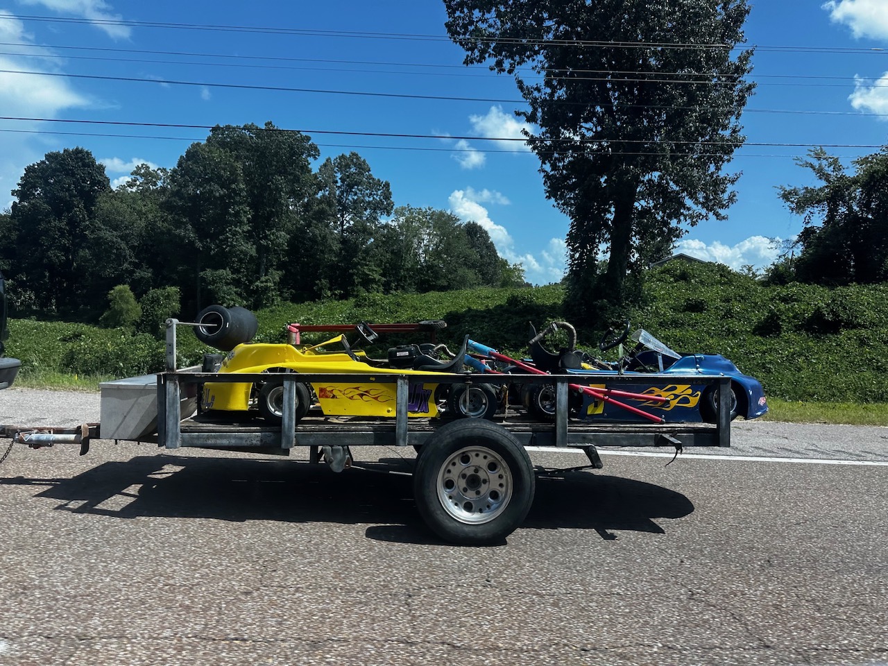 Travis's yellow 10X and Ronnie's blue 3 karts loaded on the trailer, ready to haul to Adjoining Hearts Raceway