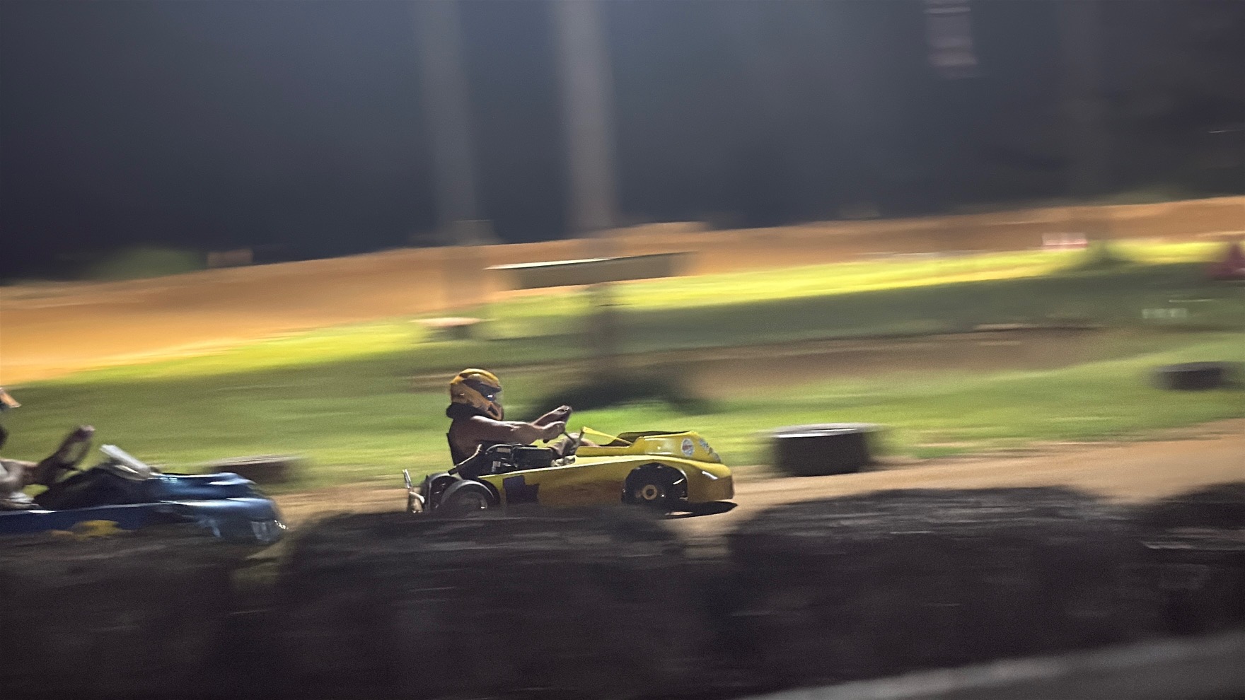 Travis's yellow 10X at speed at night in a panning action shot