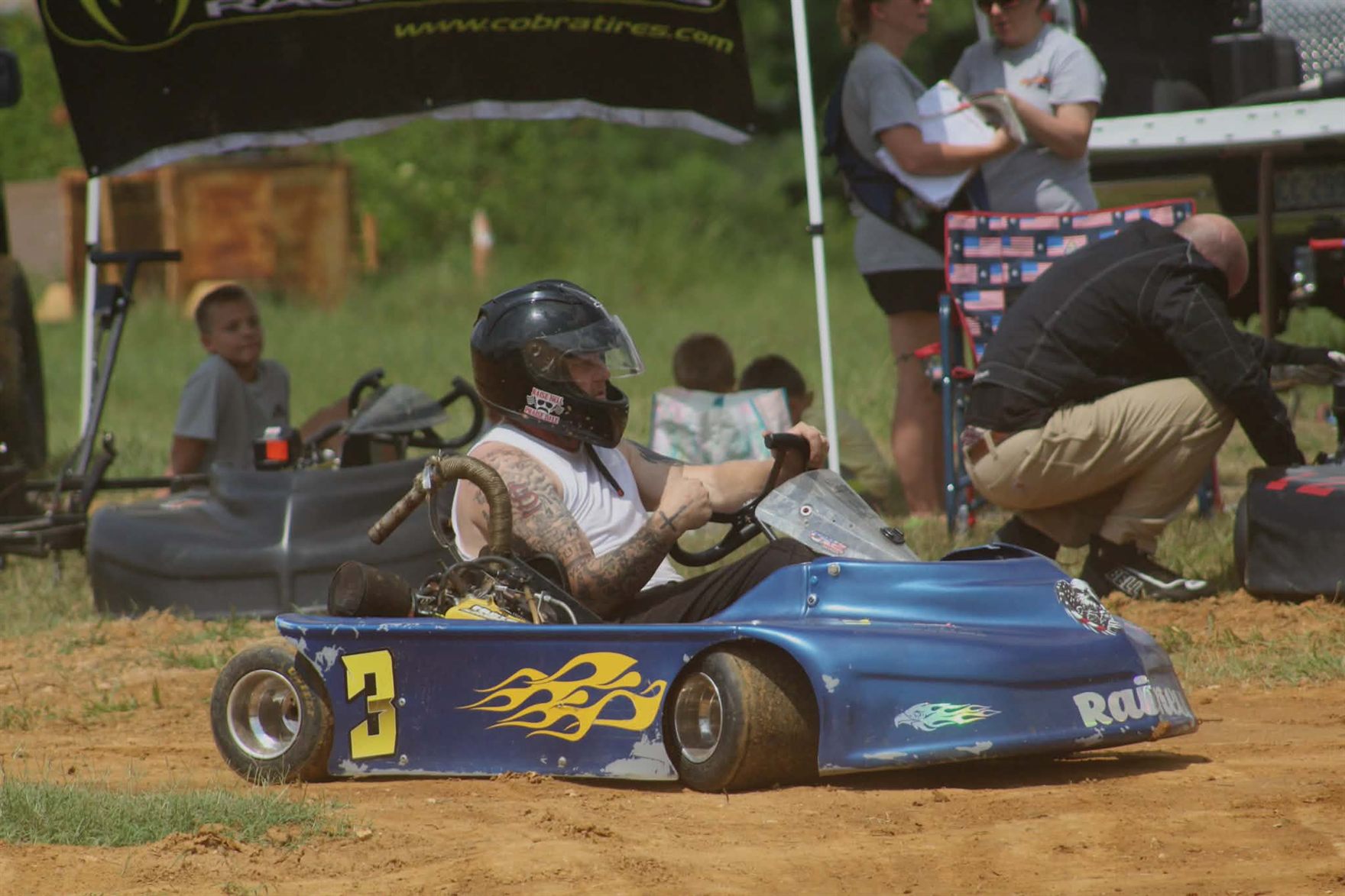 Ronnie Rainey sitting in the No. 3 kart in the pits at Camden Speedway