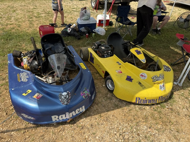 Ronnie's blue 3 and Travis's yellow 10X parked side by side in the pits