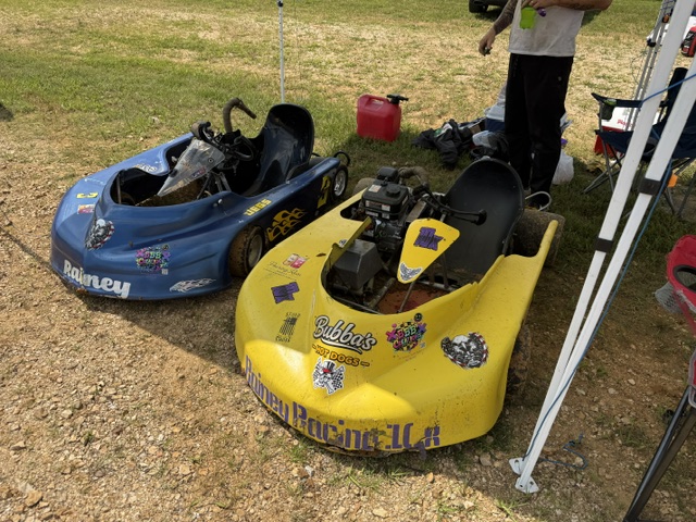 Ronnie's blue 3 and Travis's yellow 10X sitting side by side in the grass pits