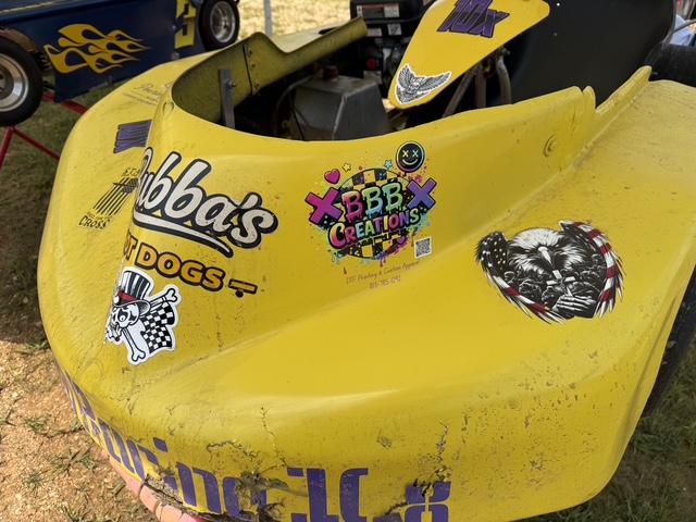 Close-up of the Bubba's Hot Dogs and BBB Creations decals on the nose of the yellow 10X kart
