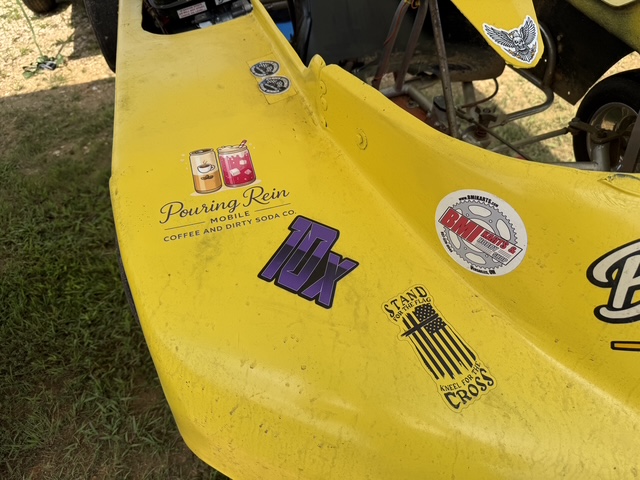 Close-up of the Pouring Rein Mobile Coffee and Dirty Soda Co. decal on the side of the 10X kart